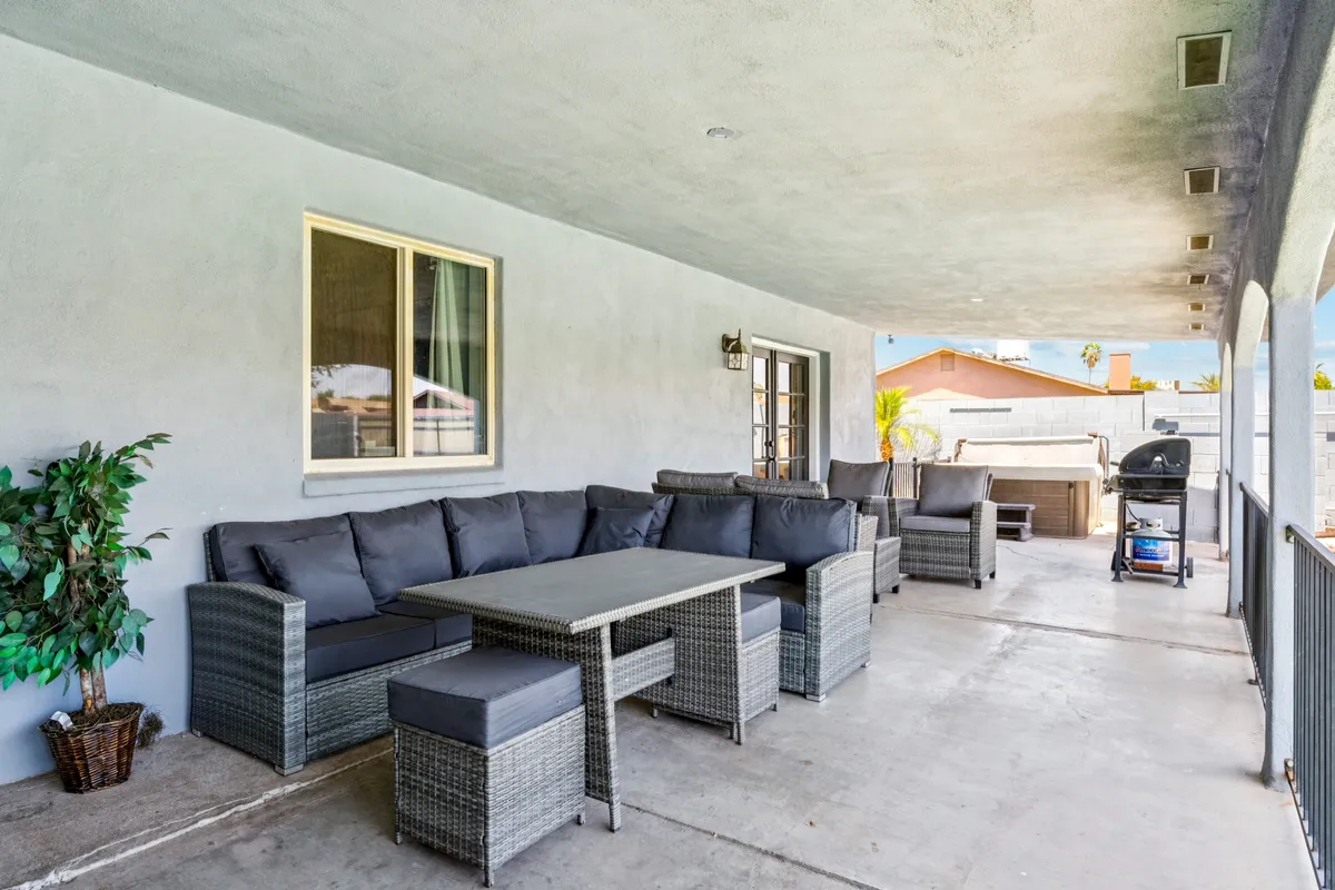 A cozy outdoor seating area featuring a table and grill, ideal for barbecues and open-air meals. The setup encourages group gatherings and relaxed dining experiences outside.